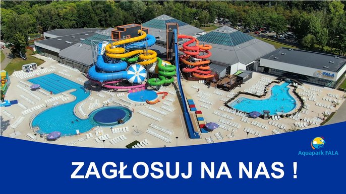 Panorama Aquaparku z lotu ptaka od strony terenu zewnętrznego Strefy Basenowej. Na pierwszym planie kolorowe megazjeżdżalnie i zjeżdżalnia Kamikaze. W tle trzy hale basenowe w kształcie piramid. Widać zewnętrzne baseny rekreacyjne i basen sportowy 